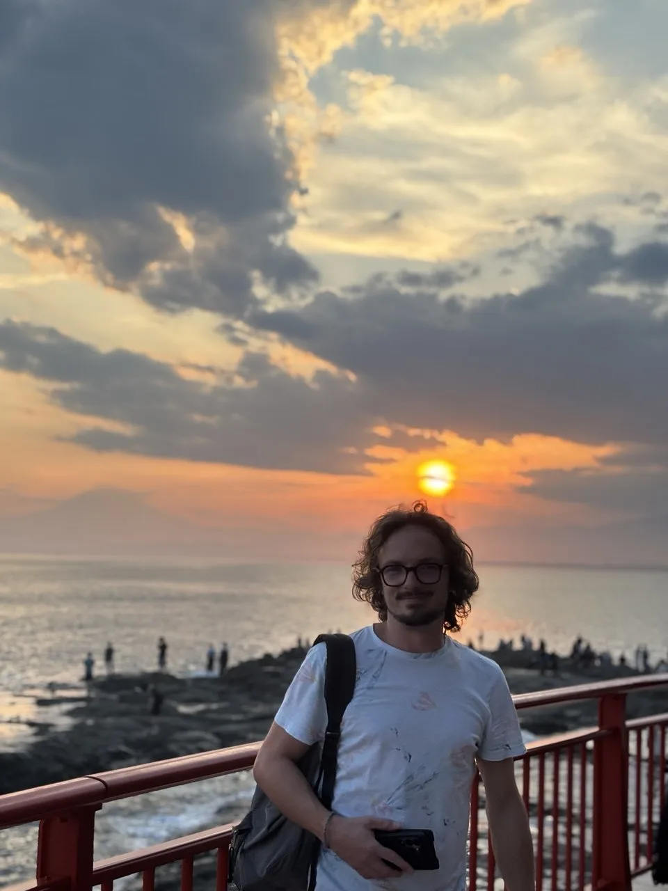 Adelin Heckel, founder of Pokadonys, at Enoshima in Japan, Mount Fuji in the background at sunset